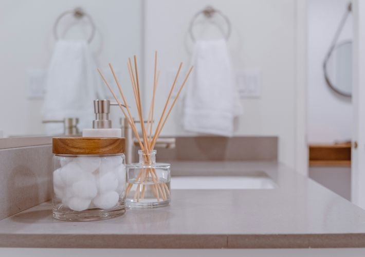 Professional bathroom cleaning, showing a sparkling clean counter and tidy hand towels.